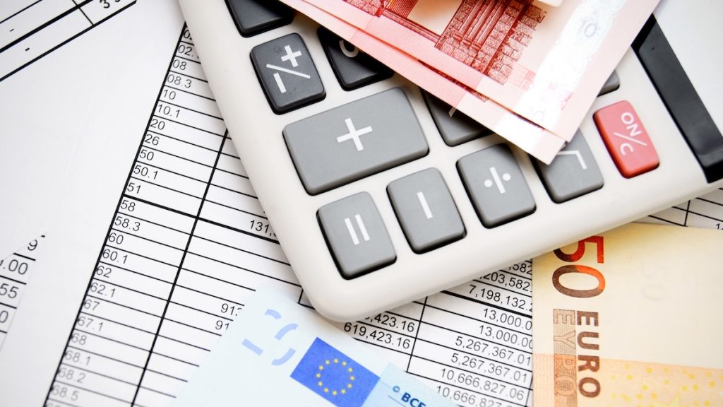 The calculator and money. On documents. The calculator and money. On documents.
